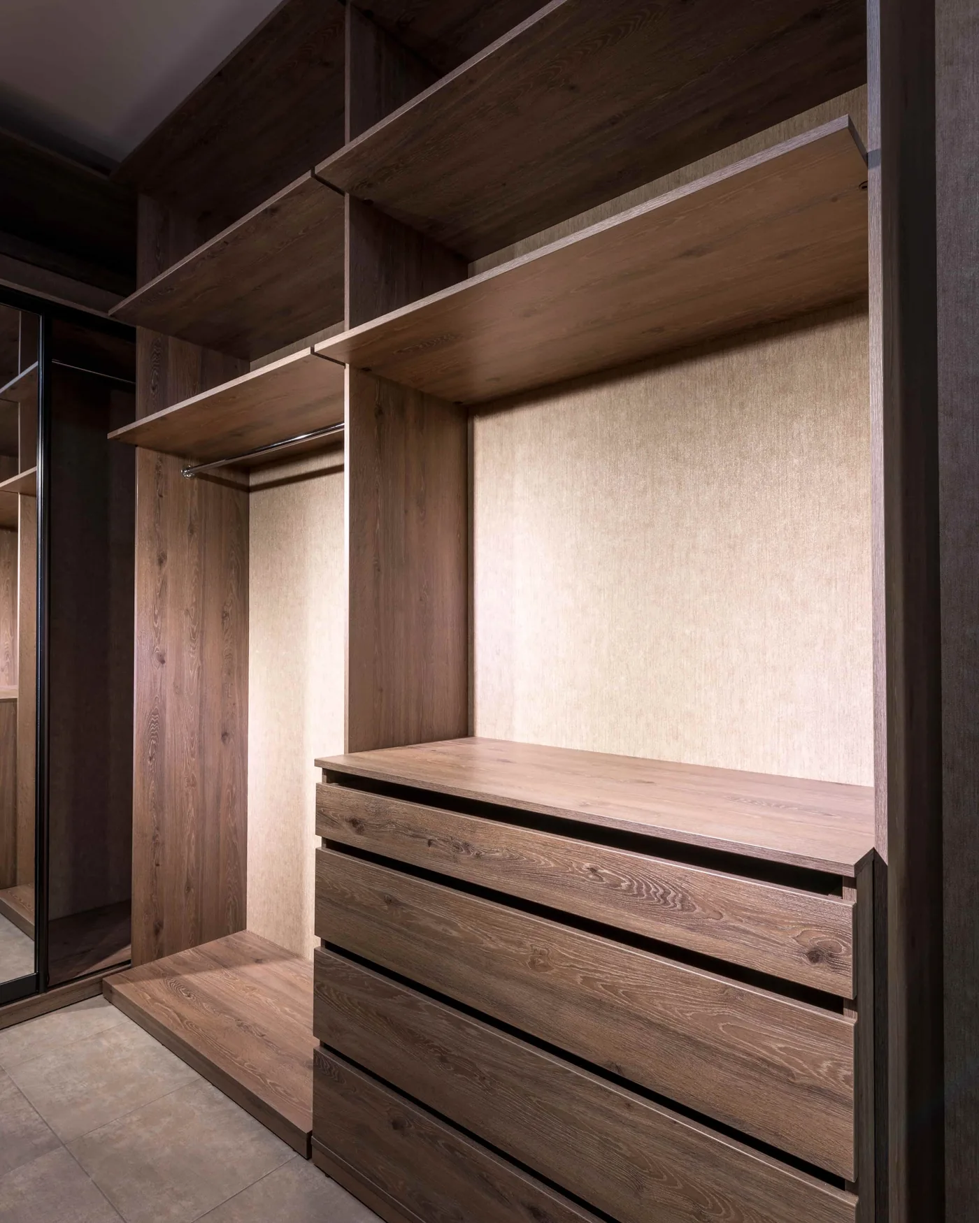 Walnut closet with a drawer chest, open shelves, hanging rails and a full-length mirror