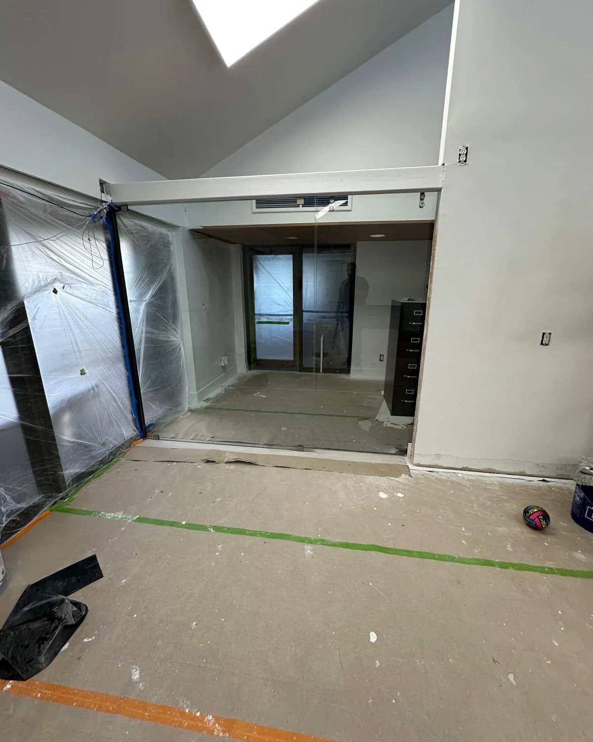 Room on a job site with the floor protected, ready for glass to be measured