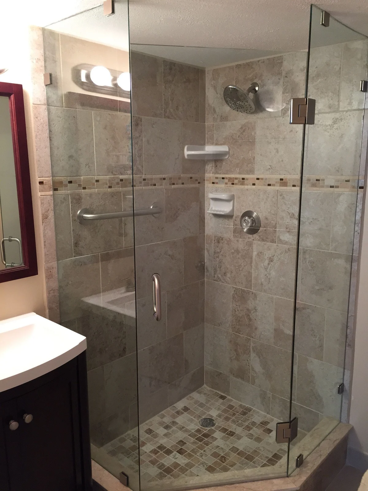 Neo-angle glass shower enclosure in a tiled corner