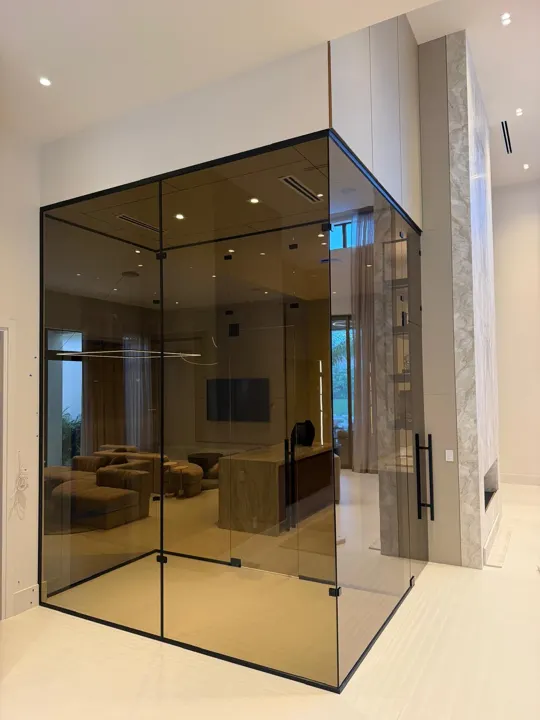 Bronze-tinted glass room with a black frame