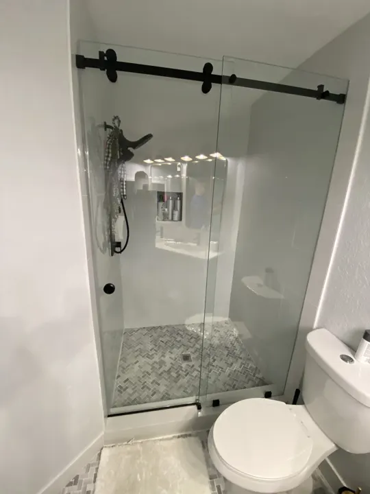Sliding shower door on black hardware
