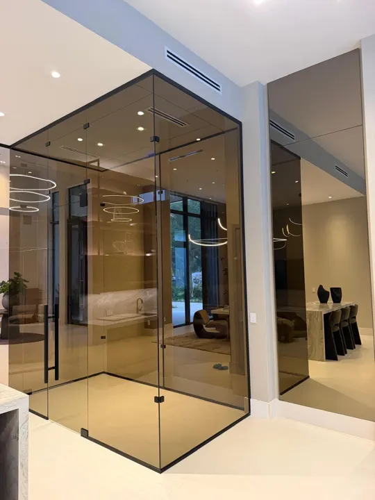 Bronze-tinted glass enclosure with a black frame