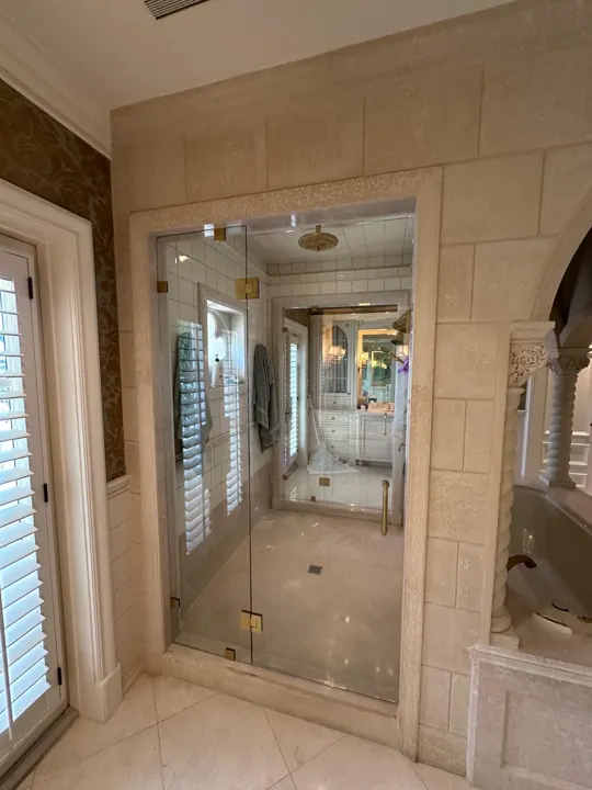 Frameless shower in a stone bathroom