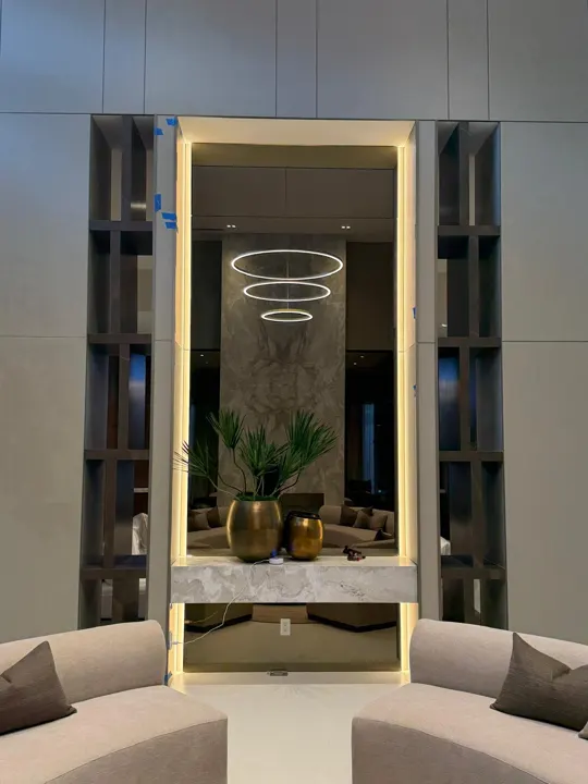 Floor-to-ceiling mirror with lighting around the frame