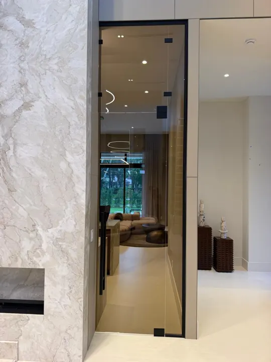 Black-framed glass door to a living room