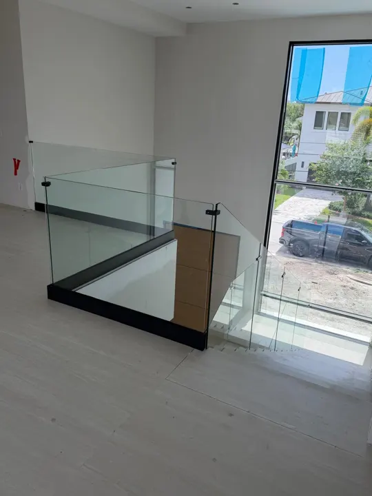 Glass railing around a stairwell opening