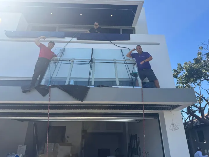 Our crew setting balcony railing glass